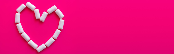 Top view of heart symbol from chewing gums on pink background, banner  - Fotó, kép