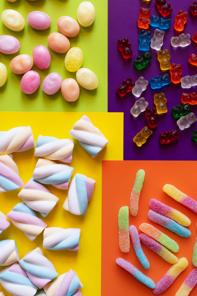 Flat lay with delicious sweets on colorful surface  - Photo, Image