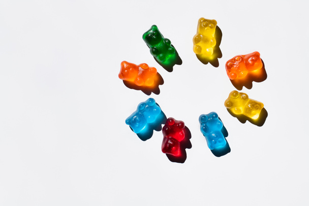 Flat lay with round from gummy bear on white background  - Photo, Image