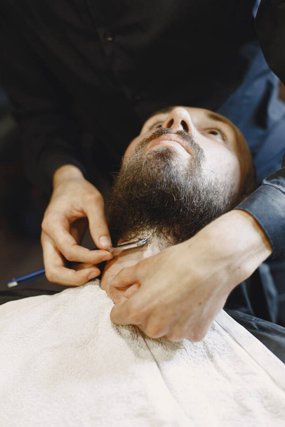 Man with a beard. Hairdresser with a client. Man with a shave. - Zdjęcie, obraz