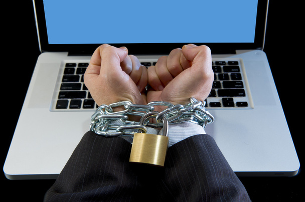 Hands of businessman addicted to work bond with chain to computer laptop in workaholic - Photo, Image