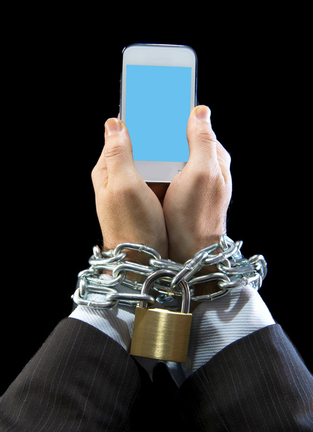 Hands of businessman addicted to work locked and enchained in mobile phone addiction - Photo, Image