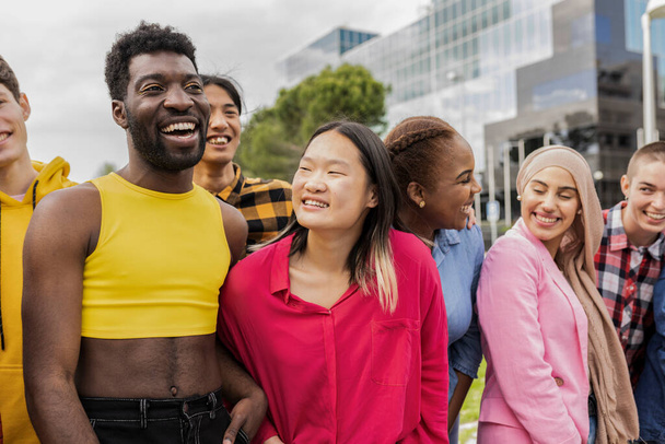 Diverse young people having fun laughing together outdoors - Multiracial people laughing out loud around the city - - 写真・画像