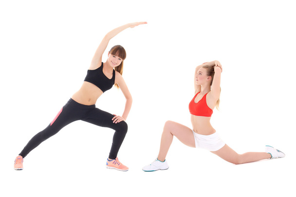 two slim sporty women doing stretching exercises isolated on whi - Photo, Image