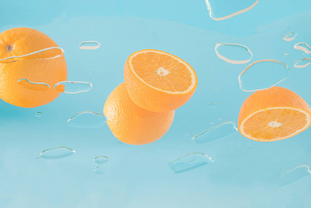 Creative summer concept with oranges on glass for a party or picnic. Bottom view. - 写真・画像