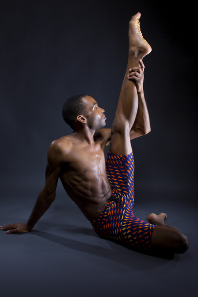 man doing yoga stretches - Фото, изображение