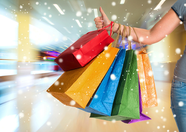Woman showing thumb up and holding shopping bags - Photo, Image