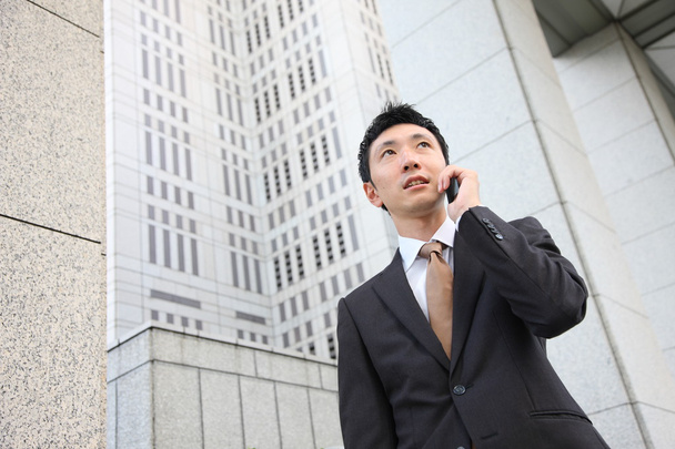 Japanese businessman talks with a mobile phone - Photo, Image