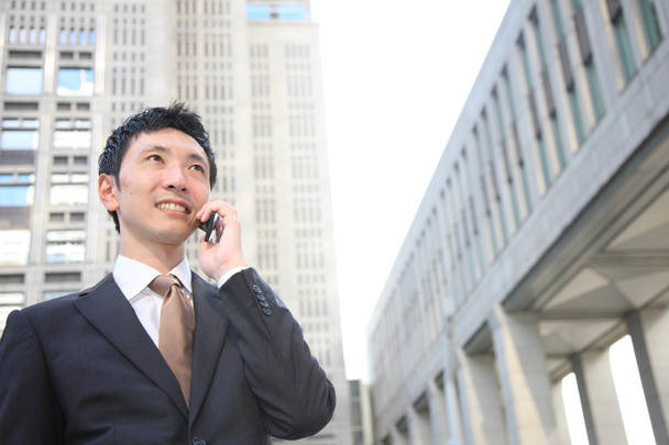 Japanese businessman talks with a mobile phone - Φωτογραφία, εικόνα