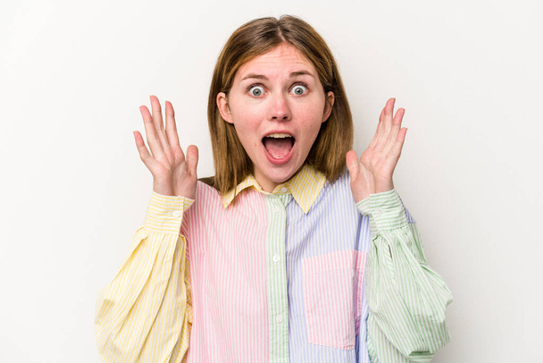 Young russian woman isolated on white background celebrating a victory or success, he is surprised and shocked. - 写真・画像