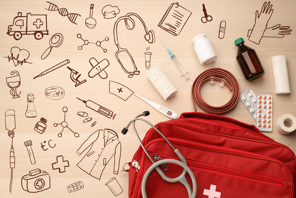 First aid kit and different images on wooden table, flat lay - Foto, Imagem