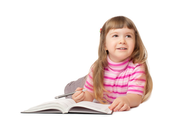 Smiling little writing girl - Valokuva, kuva