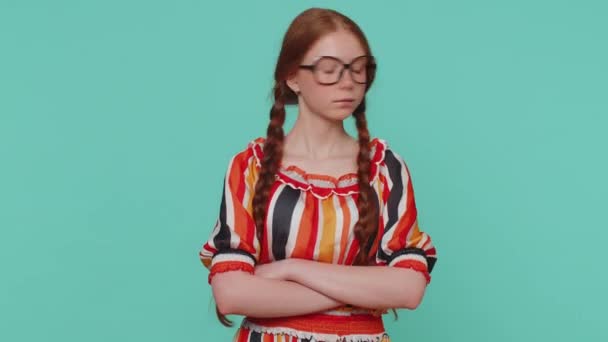 Displeased upset girl reacting to unpleasant awful idea, dissatisfied with bad quality, wave hand, shake head No, dismiss idea, dont like proposal. Young ginger teenager child alone on blue background - Footage, Video