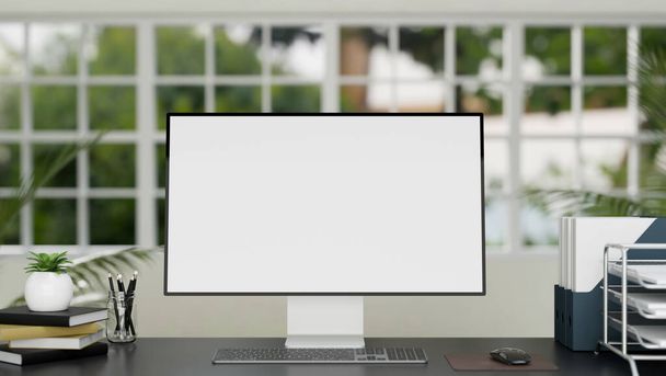 オフィスのデスクワークスペースPCの空白のデスクトップモックアップ、オフィス用品やオフィス機器とぼやけた現代の最小限の白と緑のオフィス上。3Dレンダリング、 3Dイラスト - 写真・画像