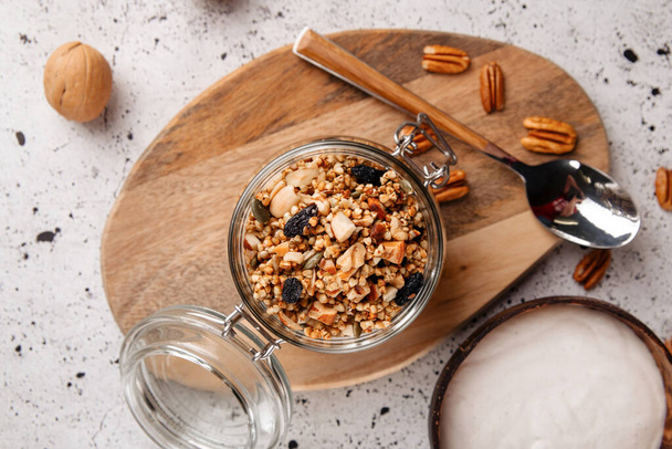 Portion of healthy granola with yogurt and nuts - Фото, зображення