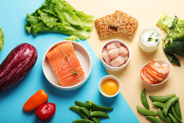 Pescatarian diet on colourful background. Vegetarian diet that includes fish or other aquatic animals. Flat lay, top view - Foto, Imagem