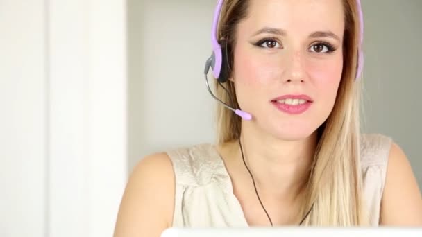 Kobieta z słuchawkami na komputerze mówić do klienta - Materiał filmowy, wideo