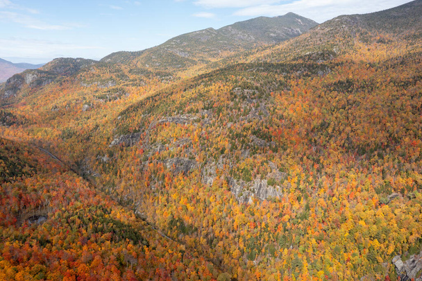 Aerial view of peak fall foliage in Keene, New York in upstate New York. - 写真・画像