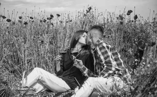 Young beautiful couple in poppy field outdoors in summer, date. - Foto, Bild