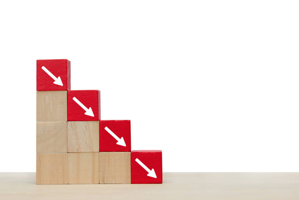 Arrow pointing down on red wooden block.  Symbol of the fall of investment or businesses - Foto, afbeelding