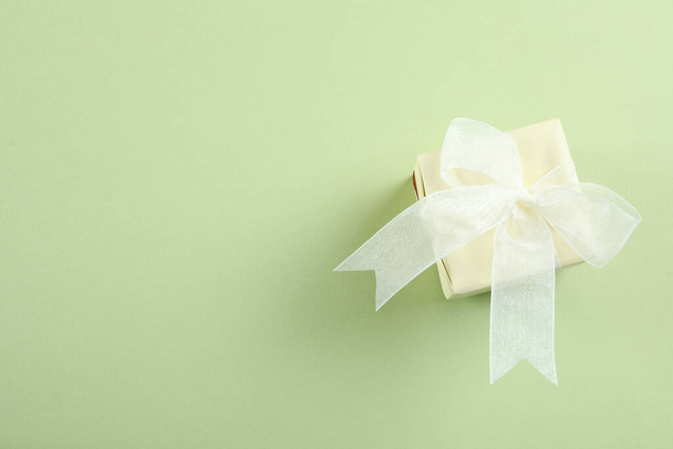Gift box on green background, space for text - Photo, image