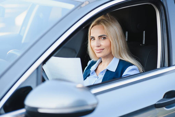 Portrait of business elegant middle-aged woman in car - Фото, зображення