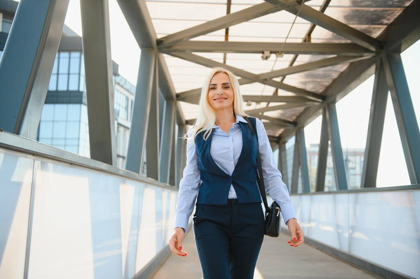 Portrait of business woman smiling outdoor. - Foto, afbeelding