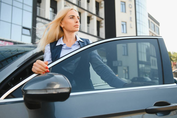 Nice business woman, standing near automobile - Fotoğraf, Görsel
