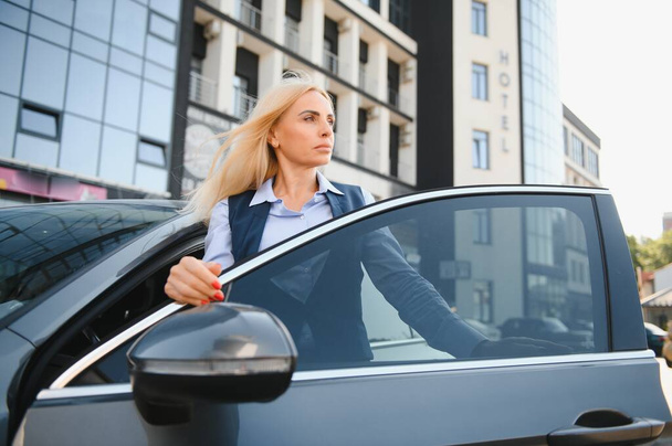 Nice business woman, standing near automobile - Photo, image
