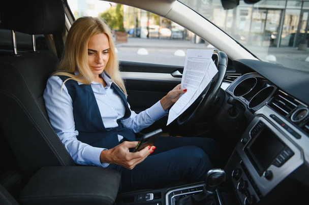 Portrait of business elegant middle-aged woman in car - Photo, Image
