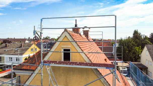 Bir çatı ustası tarafından tamir edilirken düz fayansları olan eski bir çatı. - Fotoğraf, Görsel