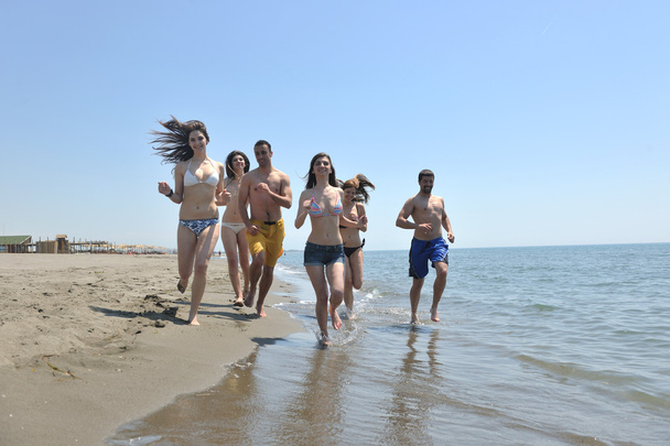 Happy group have fun and running on beach - Photo, image