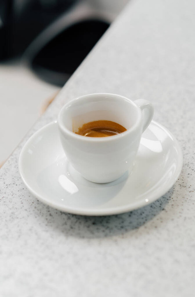Cup of espresso on table in coffee shop - Fotoğraf, Görsel