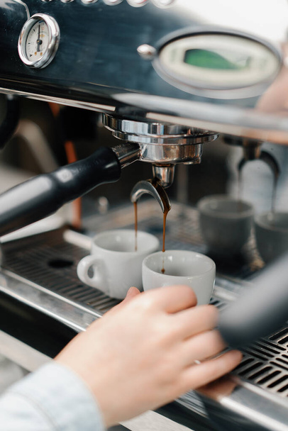 Making coffee espresso or ristretto in coffee machine. Home making hot Espresso. Coffee with froth. Espresso in a white cup. Tasty coffee. Caffeine. - Zdjęcie, obraz