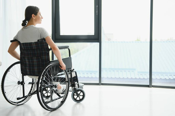 Young woman in wheelchair at home. - Fotoğraf, Görsel