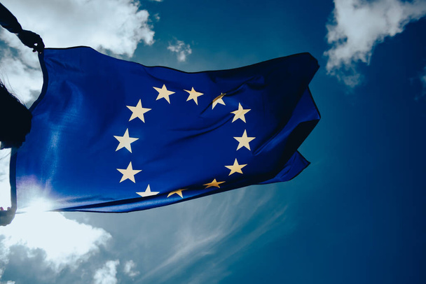 Waving European Union flag on blue sky. - Foto, Bild