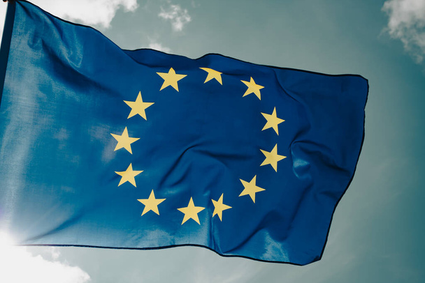 Waving European Union flag on blue sky. - Foto, Imagem