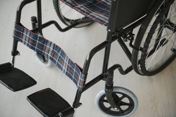 Empty wheelchair in the livingroom. Lonely and healthcare concept - Foto, immagini