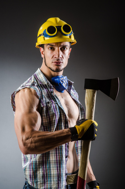Ripped muscular builder man with tools - 写真・画像