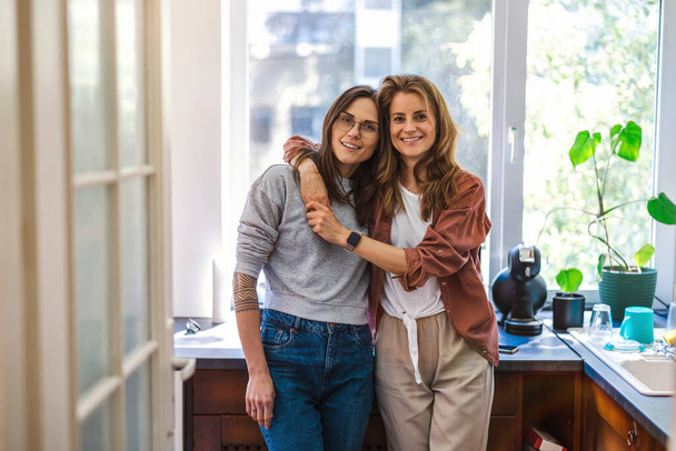 Portrait of affectionate lesbian couple embracing at home - Foto, immagini