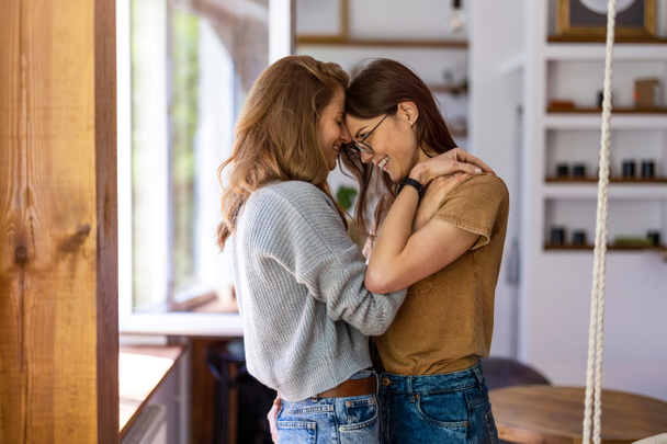 Happy affectionate lesbian couple at home - Photo, Image
