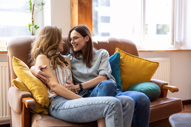 Happy affectionate lesbian couple at home - 写真・画像