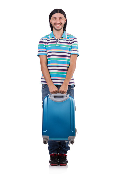 A fiatalember fehér bőröndökkel utazik. - Fotó, kép