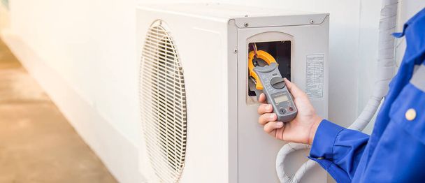 Technician checking the operation of the air conditioner. - Photo, Image