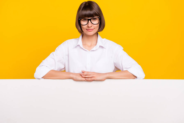 Photo of business lady hands white banner placard empty space wear specs white shirt isolated yellow color background. - Fotografie, Obrázek