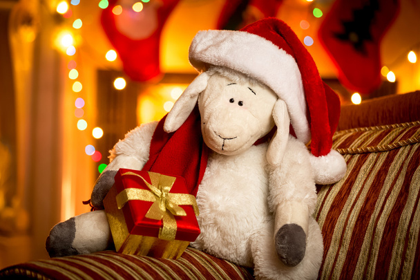 πρόβατα παιχνίδι με κιβώτιο δώρων στο διακοσμημένα για τα Χριστούγεννα σαλόνι - Φωτογραφία, εικόνα