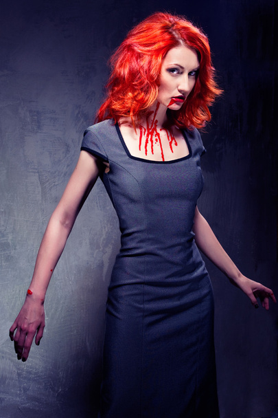 Redhead woman with blood in her lips and neck - Photo, Image