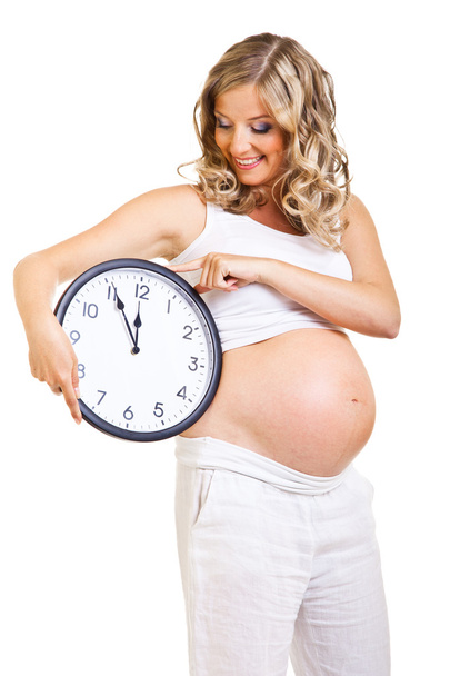 Pregnant woman with clock isolated on white - Foto, Imagem