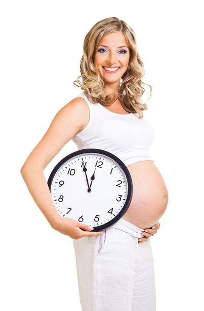 Pregnant woman with clock isolated on white - Photo, image