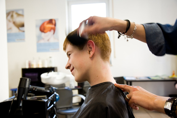 garotinho sorridente com cabelo vermelho no cabeleireiro
 - Foto, Imagem